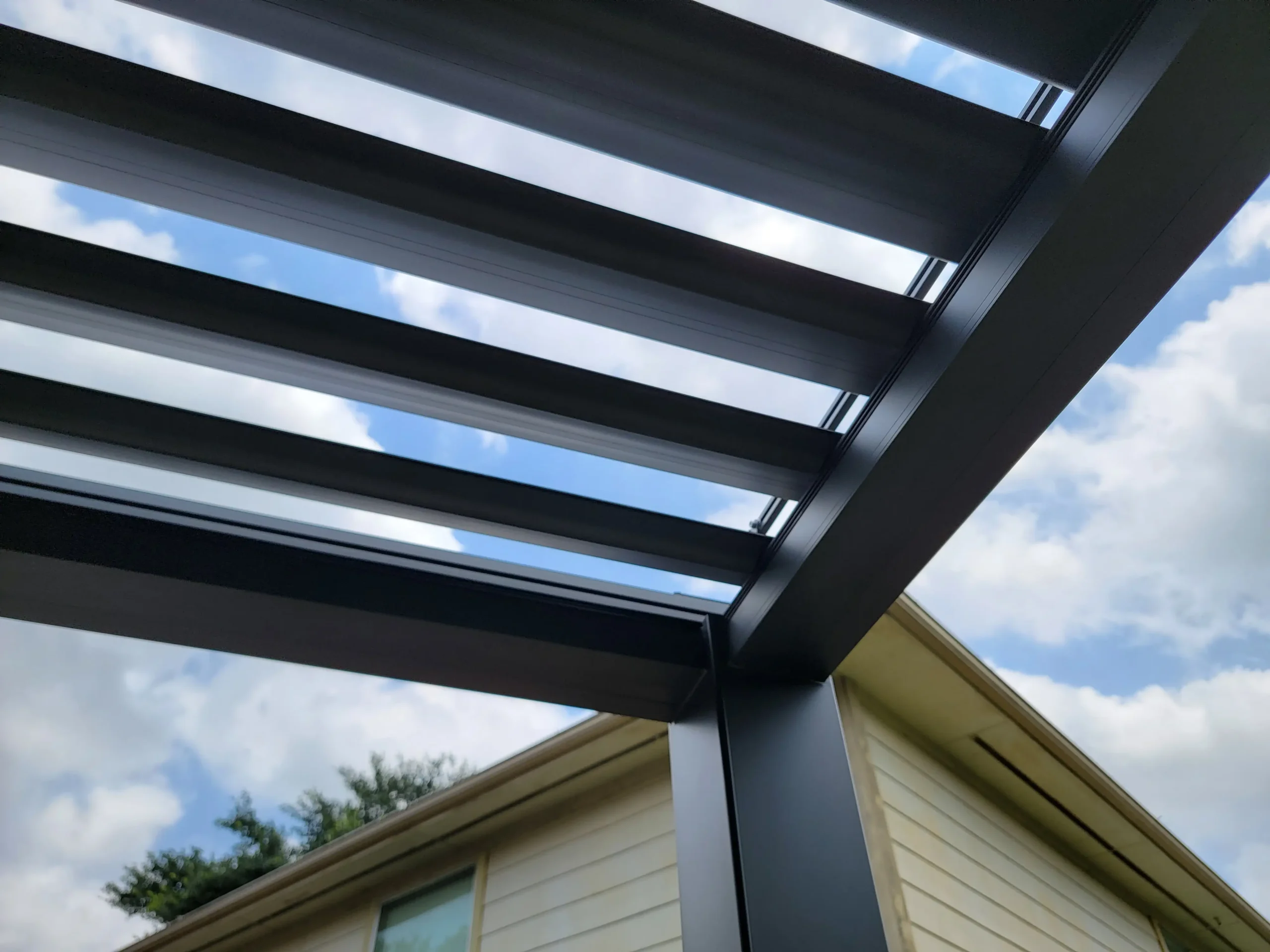 Close-up of dark gray solar canopy structural slats