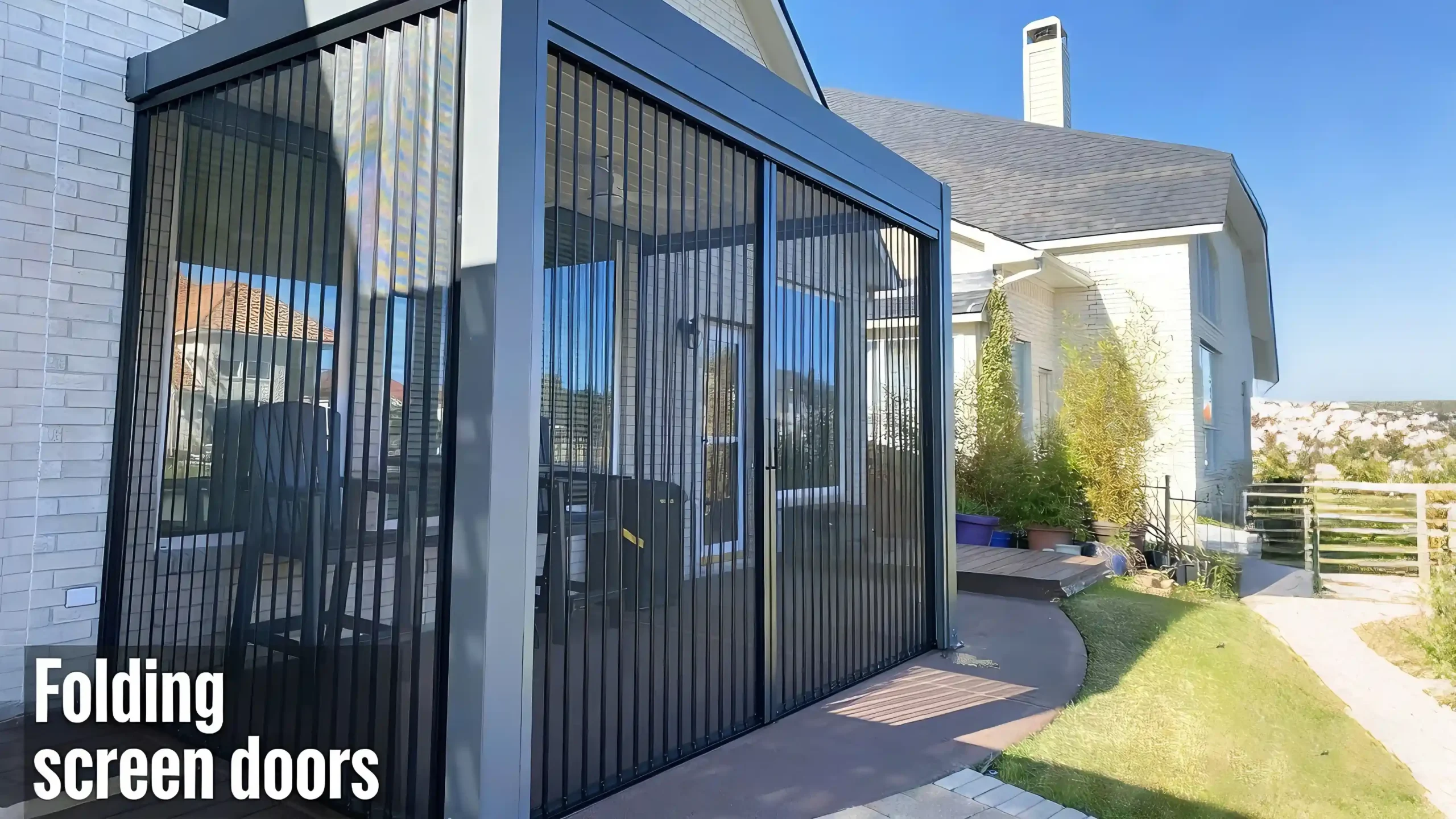 Enclosed pergola with folding screen doors, black frame, adjacent to a residential home.