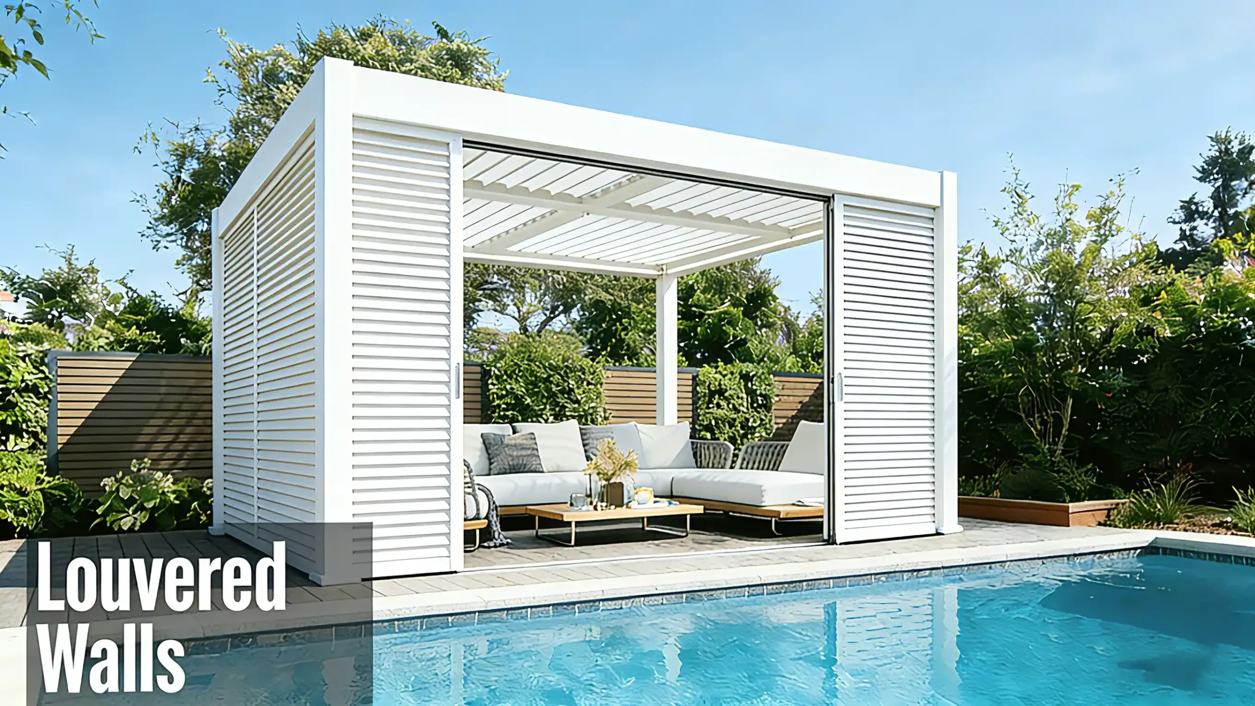 White pergola with louvered wall, outdoor seating, adjacent to a swimming pool.