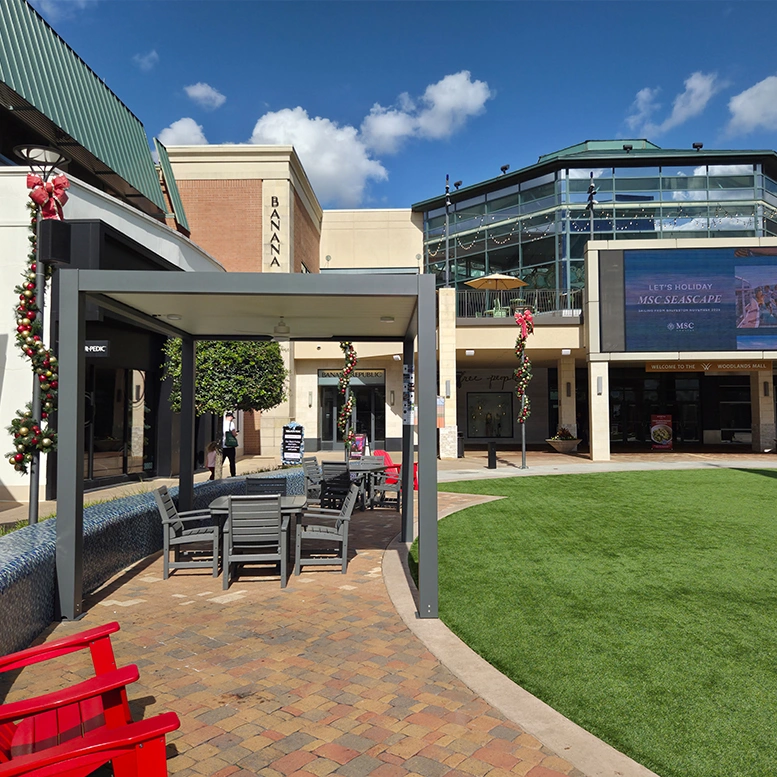 Outdoor Pergola covering a gray dining set, on a brick patio
