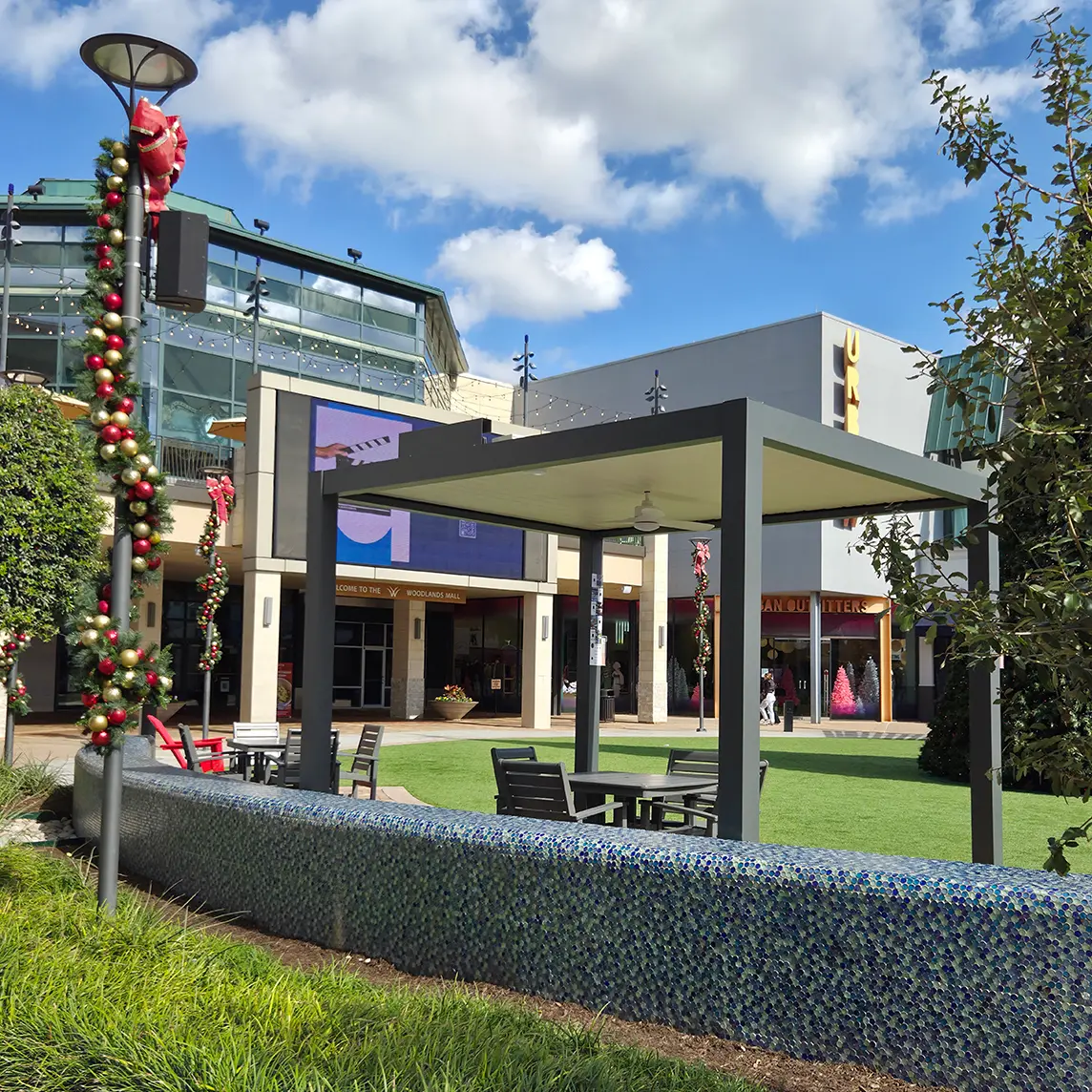 Outdoor awning with dining set, in a mall plaza decorated for Christmas