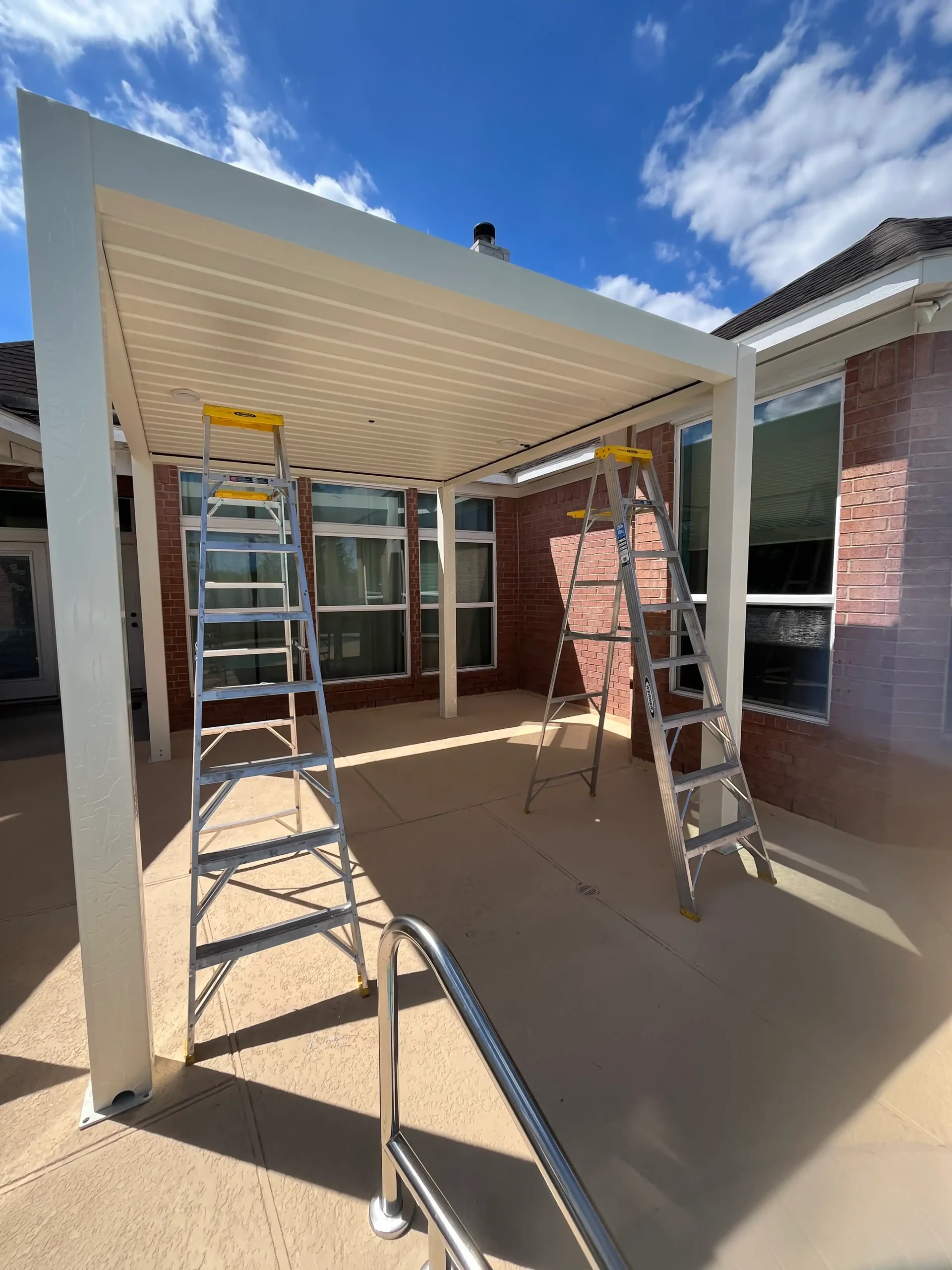 pergola installation process on concrete pool deck