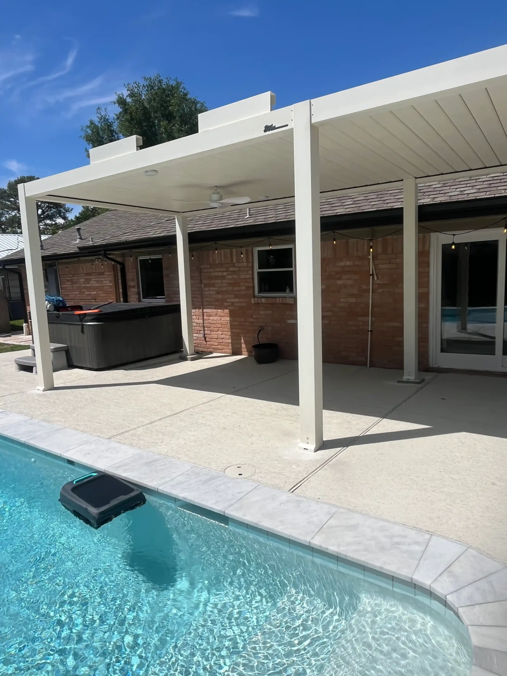 white louvered shade structure covering pool and hot tub area in Houston backyard