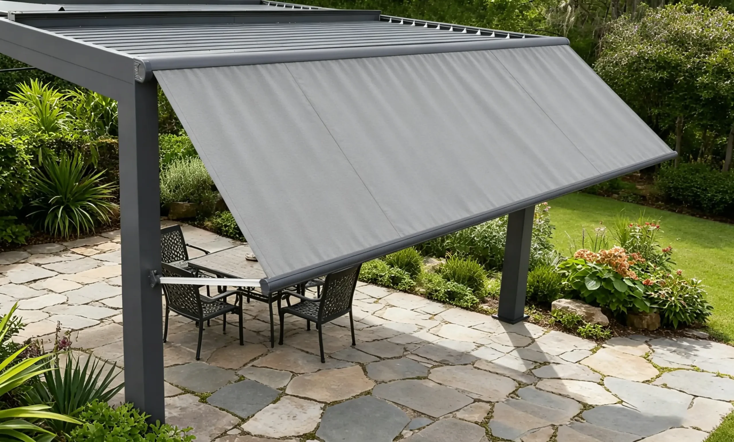 Gray drop arm awning installed on a pergola, shading a backyard patio dining area