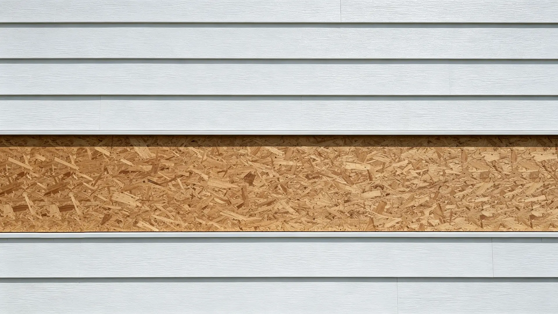 Cut away the siding at the ledger location to expose the sheathing.